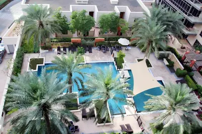 an overhead view of a resort with palm trees and a pool at South Ridge 1, Downtown Dubai - Mint Stay in Dubai