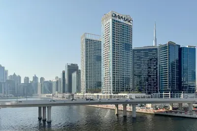 a bridge over a river in a city with tall buildings at Partial Canal View, Business Bay in Dubai