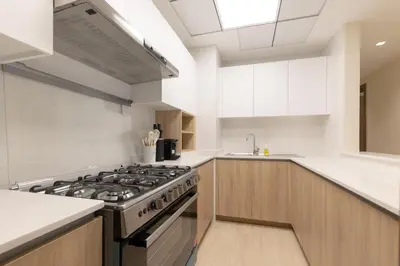 a kitchen with a stove and a sink at Partial Canal View, Business Bay in Dubai
