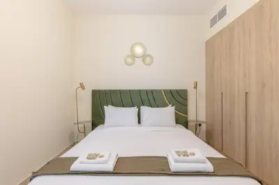 a bedroom with a large bed with two towels on it at Partial Canal View, Business Bay in Dubai