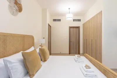 a bedroom with a bed with white sheets and pillows at Partial Canal View, Business Bay in Dubai
