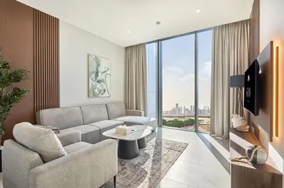 a living room with a couch and a large window at STAY BY LATINEM Luxury 1BR Holiday Home CVG 1410 Near Burj Khalifa in Dubai