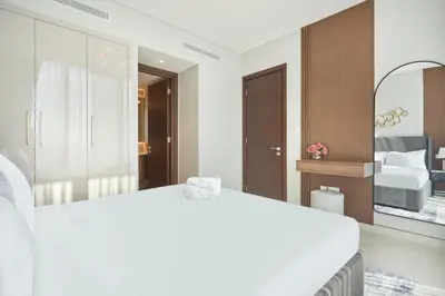 a bedroom with a large white bed and a mirror at STAY BY LATINEM Luxury 1BR Holiday Home CVG 1410 Near Burj Khalifa in Dubai