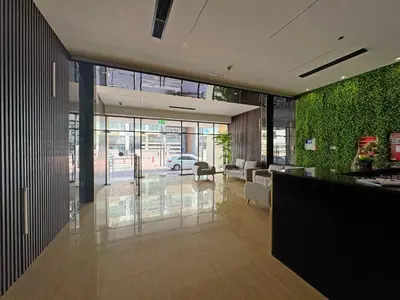a lobby with a green wall in a building at Modern & Stylish Studio Retreat in Dubai