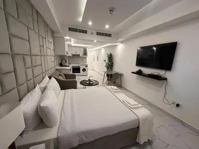 a bedroom with a bed and a tv in a room at Modern & Stylish Studio Retreat in Dubai