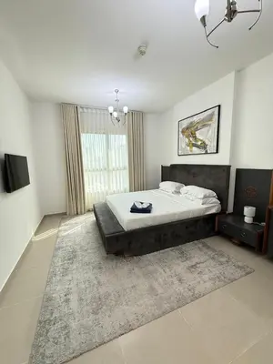 a bedroom with a large bed and a rug at Bright 1BR Apartment in JVC - JLiving in Dubai
