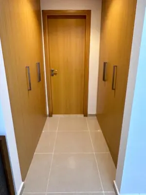 a hallway with two doors and a tiled floor at Bright 1BR Apartment in JVC - JLiving in Dubai