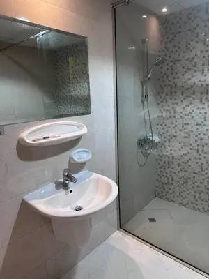 a bathroom with a sink and a shower at Bright 1BR Apartment in JVC - JLiving in Dubai
