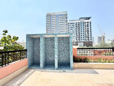 a blue metal wall on a balcony with buildings at Homes2Retreat - Very Spacious Studio in the Heart of JVC in Dubai
