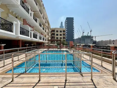 a swimming pool on the roof of a building at Homes2Retreat - Very Spacious Studio in the Heart of JVC in Dubai