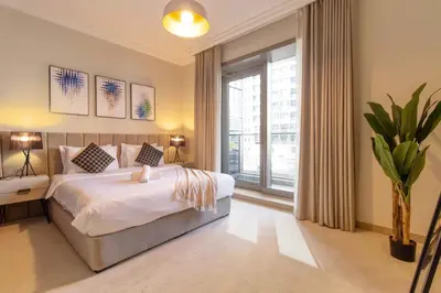 a bedroom with a large bed and a large window at Luxurious 2Bed in Sparkle Tower-Marina View in Dubai