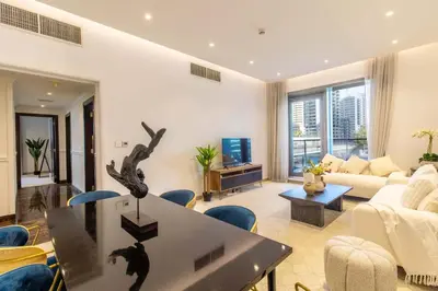 a living room with a couch and a table at Luxurious 2Bed in Sparkle Tower-Marina View in Dubai