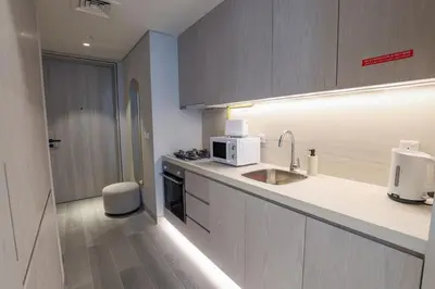 a kitchen with a sink and a microwave at Modern Studio in Condor Concept7, JVC in Dubai