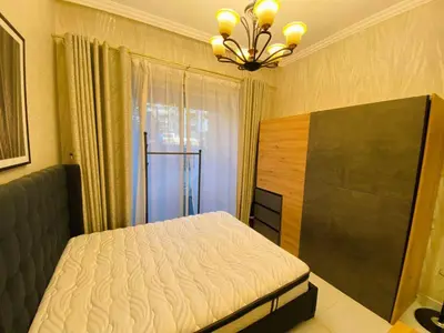 a bedroom with a bed and a chandelier at Dubai Luxury Apartments In a good place in Dubai