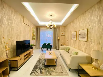 a living room with a couch and a tv at Dubai Luxury Apartments In a good place in Dubai