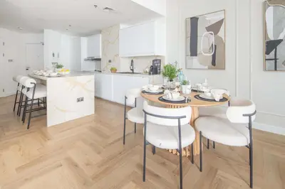 a kitchen and dining room with a table and chairs at Frank Porter - Torch Tower in Dubai