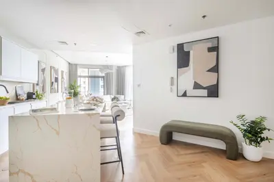 a kitchen and living room with white walls and a counter at Frank Porter - Torch Tower in Dubai