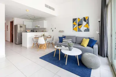 a living room with a couch and a table at Frank Porter - Marina Views in Dubai