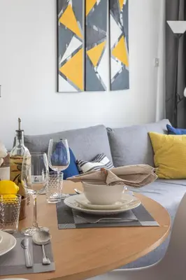 a wooden table with a plate of food on top of a couch at Frank Porter - Marina Views in Dubai