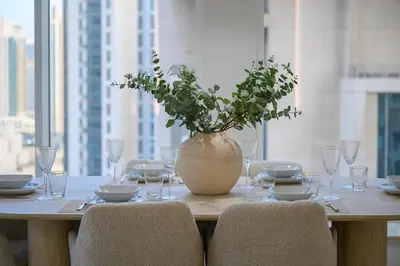 a table with a vase with a plant on it at Luxury Apartment with Full Burj & Fountain Views in Dubai