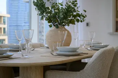 a wooden table with a vase on top of it at Luxury Apartment with Full Burj & Fountain Views in Dubai