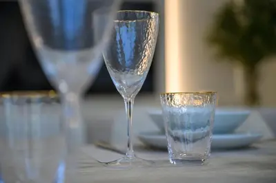 a couple of glasses sitting on top of a table at Luxury Apartment with Full Burj & Fountain Views in Dubai
