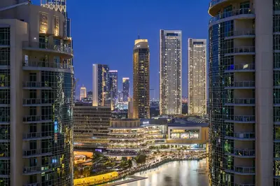 a view of a city at night with tall buildings at Luxury Apartment with Full Burj & Fountain Views in Dubai