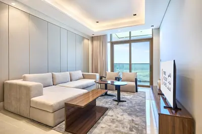 a living room with a couch and a tv at Two Bedroom Apartment in Nobles Tower by The S Holiday Homes in Dubai
