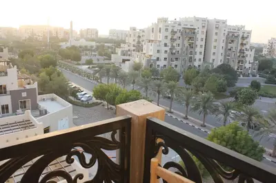 a view of a city from a balcony at New 1BED Apartment in Remraam, Dubai Land, Motor city, Damac hills, Mudoon area in Dubai