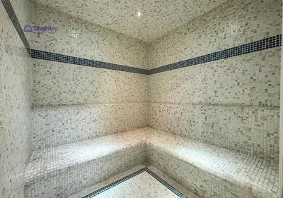 a corner of a shower in a room with tiles at Dream Inn - Modern 1BR in Arjan in Dubai