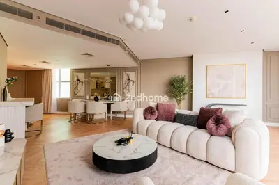 a living room with a white couch and a table at Stylish 2Bedroom in DIFC Dubai Newly Furnished in Dubai