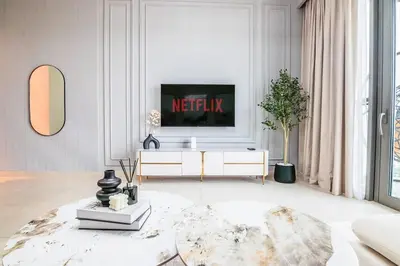a living room with a tv on a white wall at Downtown Views 1 - Direct Access to Dubai Mall in Dubai