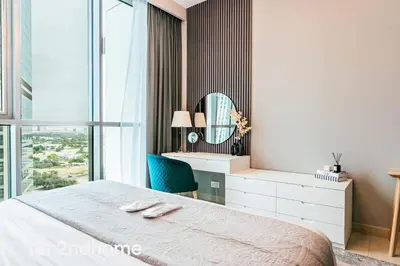 a bedroom with a bed and a desk and a mirror at Downtown Views 1 - Direct Access to Dubai Mall in Dubai