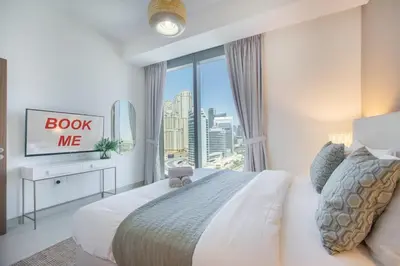a bedroom with a large bed and a window at StayShort - Elegant 2BR in Dubai Marina - Luxury Awaits You in Dubai
