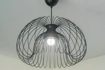 a metal chandelier is hanging from a ceiling at StayShort - Elegant 2BR in Dubai Marina - Luxury Awaits You in Dubai