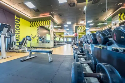 a gym with a row of dumbbells in at Renovated 1BR with Partial Sea and City Views Near Beach, Elite Residence, Dubai Marina by Deluxe Holiday Homes in Dubai