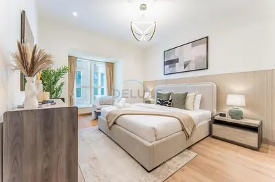 a bedroom with a bed and a living room at Renovated 1BR with Partial Sea and City Views Near Beach, Elite Residence, Dubai Marina by Deluxe Holiday Homes in Dubai