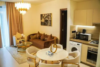 a living room with a couch and a table at Vserve 2BR Perfect Blend of Luxury Comfort & Convenience in Dubai