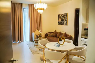 a living room with a table and a couch at Vserve 2BR Perfect Blend of Luxury Comfort & Convenience in Dubai