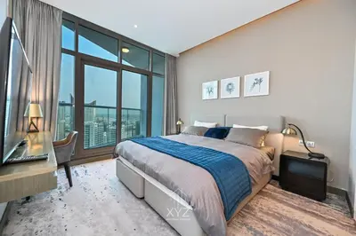 a bedroom with a large bed and a large window at Luxury & Modern studio near Burj Khalifa in Dubai