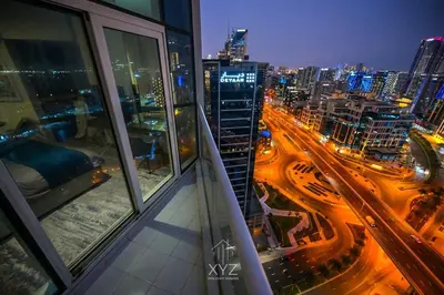 a view of a city at night from a building at Luxury & Modern studio near Burj Khalifa in Dubai