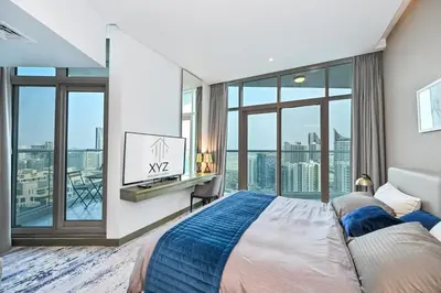 a bedroom with a bed and a large window at Luxury & Modern studio near Burj Khalifa in Dubai