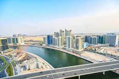 a city with a bridge and a river and buildings at Luxury & Modern studio near Burj Khalifa in Dubai