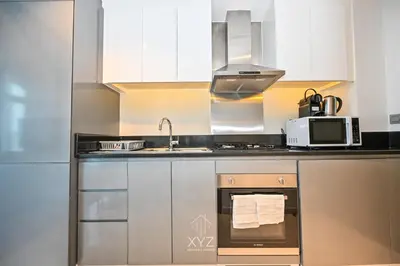 a kitchen with a sink and a microwave at Luxury & Modern studio near Burj Khalifa in Dubai