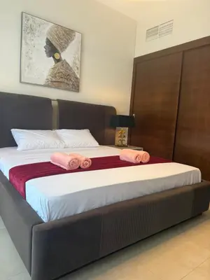 a bedroom with a large bed with pink towels on it at Sparkle Towers by Swarovski - Dubai Marina - High Floor - Beach Resort Sunset view in Dubai