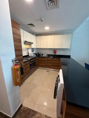 a kitchen with white cabinets and a counter top at Sparkle Towers by Swarovski - Dubai Marina - High Floor - Beach Resort Sunset view in Dubai