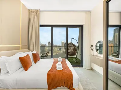a bedroom with a bed and a large window at Casa Tranquila Luxury Suites with Burj Khalifa & Canal Views in Dubai