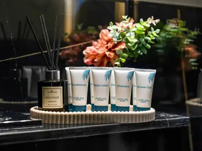a group of three products on a table with a bottle at Casa Tranquila Luxury Suites with Burj Khalifa & Canal Views in Dubai