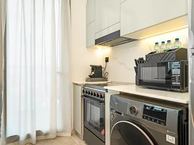 a kitchen with a microwave and a dishwasher at Casa Tranquila Luxury Suites with Burj Khalifa & Canal Views in Dubai