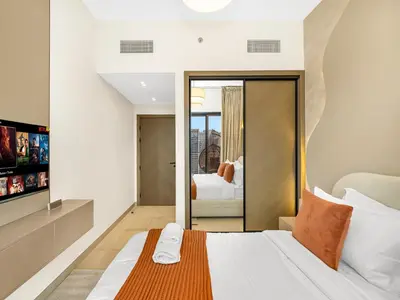 a bedroom with a large bed with a mirror at Casa Tranquila Luxury Suites with Burj Khalifa & Canal Views in Dubai